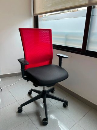 Silla de oficina ergonómica roja y negra.