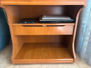 Mueble de TV de madera con estante.