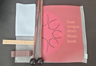 Hank drum rosa con libro de música