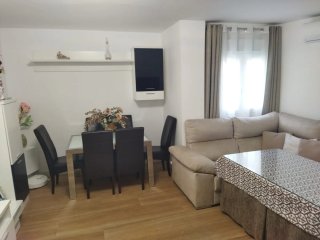 Mesa camilla con ropa y cristal.