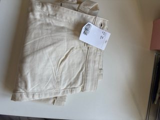 Pantalón corto beige con detalles dorados