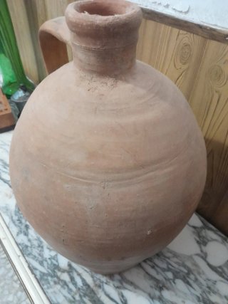 Antiguo cántaro de barro con asa