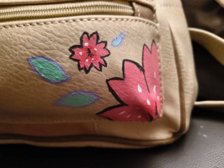 Mochila pequeña beige con flores y gato