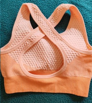 Top deportivo cruzado naranja y rosa