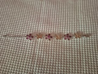 Pulsera flores y mariposas plateada