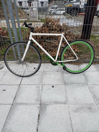 Bicicleta urbana blanca con ruedas verdes