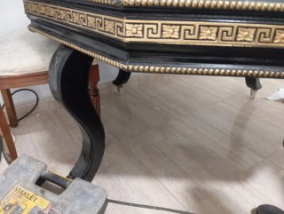 Mesa auxiliar negra con detalles dorados