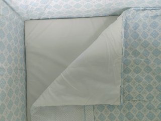Minicuna de bebé con ropa de cama