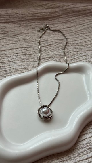 Collana con perla bianca e ciondolo argentato