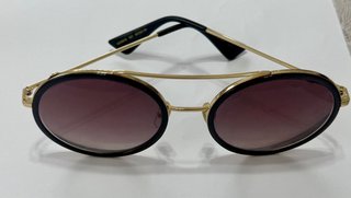 Gafas de sol Gucci doradas y negras