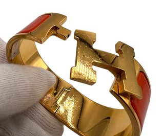 Pulsera Hermès Clic Clac Oro y Naranja