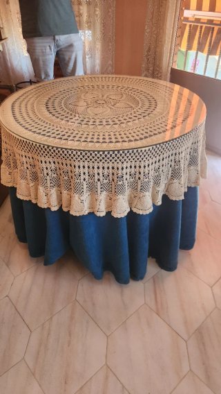 Mesa redonda de madera con cristal y mantel
