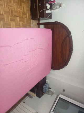 Cama de madera con colchón rosa