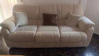 Sofá de tela beige con cojines