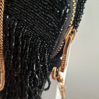 Bolso fiesta UTERQUE negro y dorado