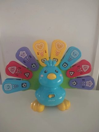 Juguete musical pavo real bebé