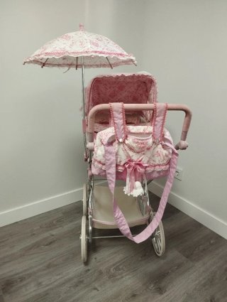 Cochecito de muñecas rosa con capota