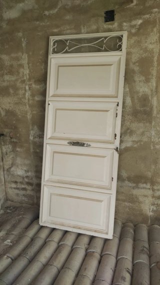Puerta de calle blanca con reja