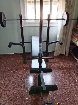 Banco de pesas y barra con discos