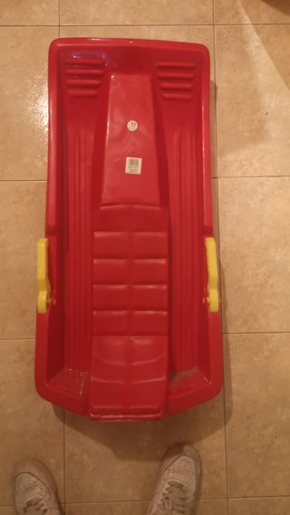 Trineo rojo con asas amarillas