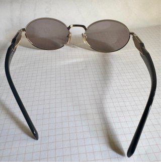 Gafas de sol Prada doradas y negras