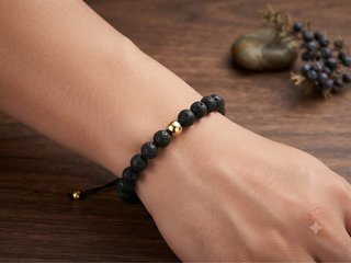 Pulsera lava negra y balin de acero