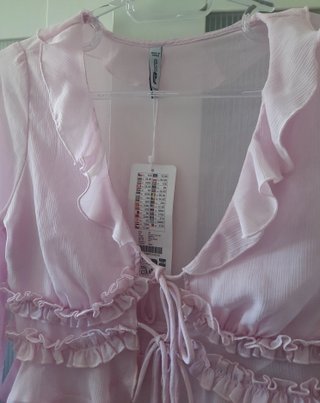 Blusa rosa manga larga con volantes