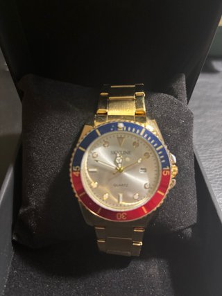 Reloj SKYLINE dorado y multicolor