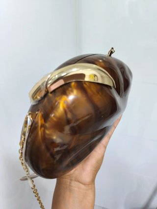 Bolso de mano tipo clutch marrón y dorado
