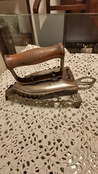 Plancha antigua de ropa con soporte