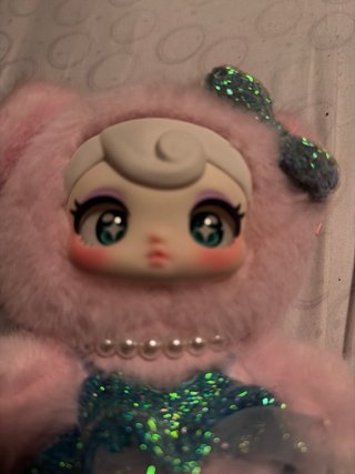 Muñeca de peluche rosa con vestido