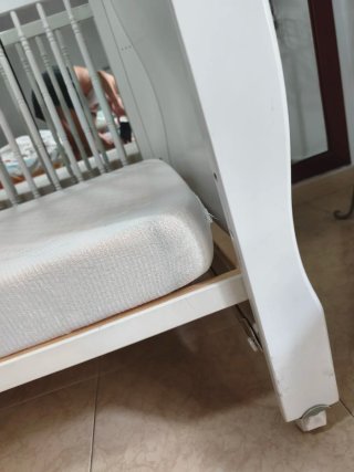 Cuna de bebé blanca estilo clásico con ruedas
