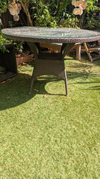 Tavolo rotondo in rattan marrone con piano in vetro spesso