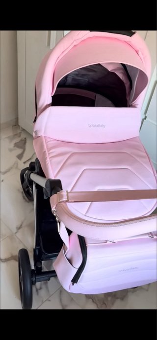Carro de bebé rosa con bolso