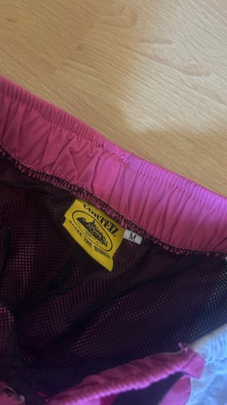 Pantalones cortos Corteiz M rosa y blanco