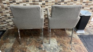 Dúo de sillas grises y mesa de cristal