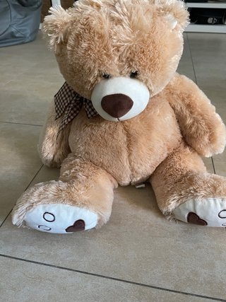 Oso de peluche marrón con lazo