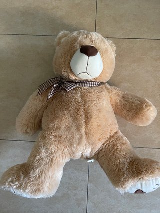 Oso de peluche marrón con lazo