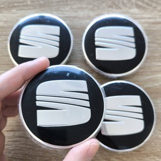 TAPABUJES SEAT 63mm NEGROS CON EMBLEMA PLATA