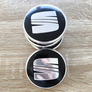 TAPABUJES SEAT 63mm NEGROS CON EMBLEMA PLATA