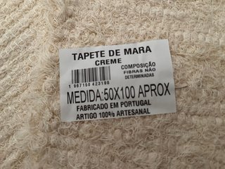 Alfombra tejida beige con flecos