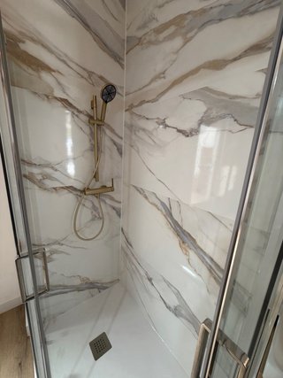 Baño reformado azul y mármol