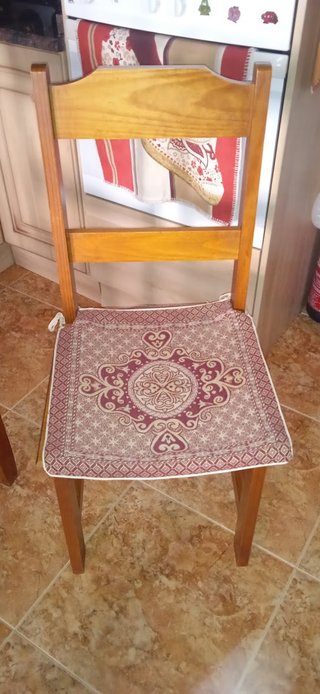 Mesa de madera con tapa de cristal y cuatro sillas