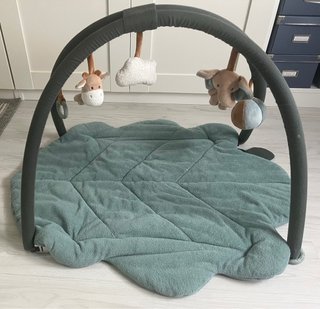 Gimnasio para bebé con arco y peluches.
