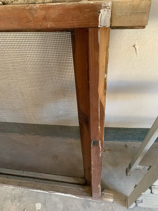 Ventana antigua de madera con mosquitera