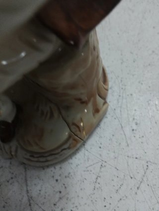 Figura de porcelana de hombre sentado
