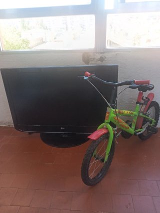 Bici infantil verde y roja y una tele Lg