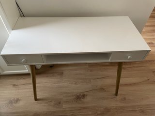 Escritorio blanco con cajones y patas de madera