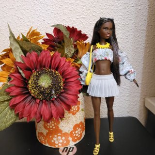 Muñeca barbie con vestido floral y bolso amarillo