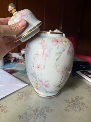 Jarrón de porcelana con tapa y flores.